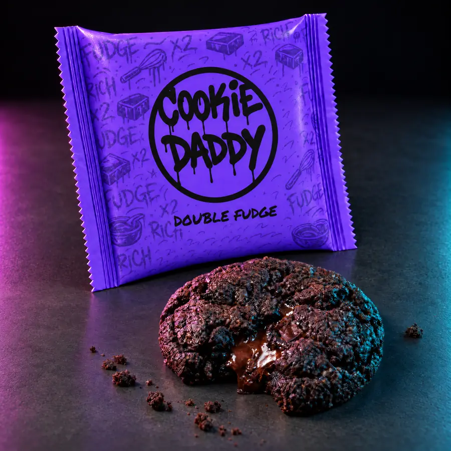 Neon purple Cookie Daddy wrapper, black ring tag with DOUBLE FUDGE printed under it, unwrapped double fudge cookie in front on dark concrete
